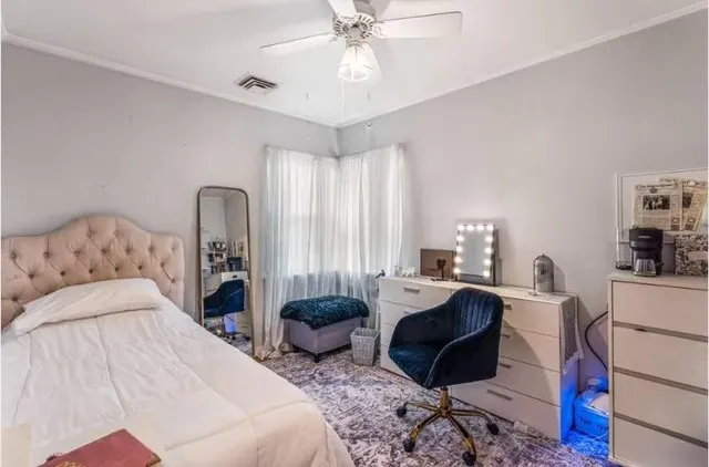 a bedroom with furniture a bed and a chandelier