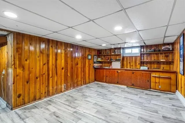 a view of empty room with wooden walls