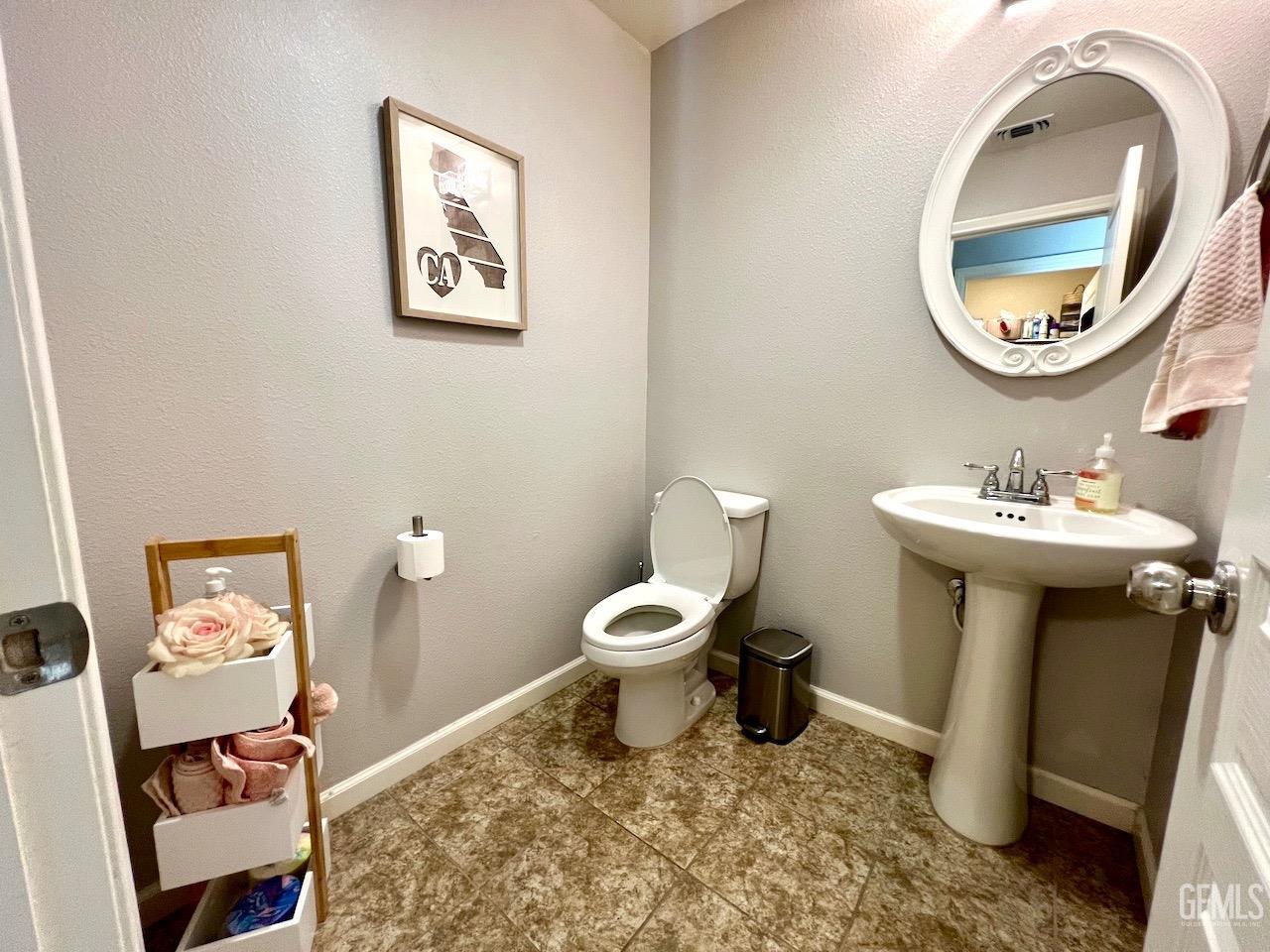 Undisclosed Address Atascadero, CA 93422 - Photo 20 of 30 a bathroom with a toilet a sink and a mirror