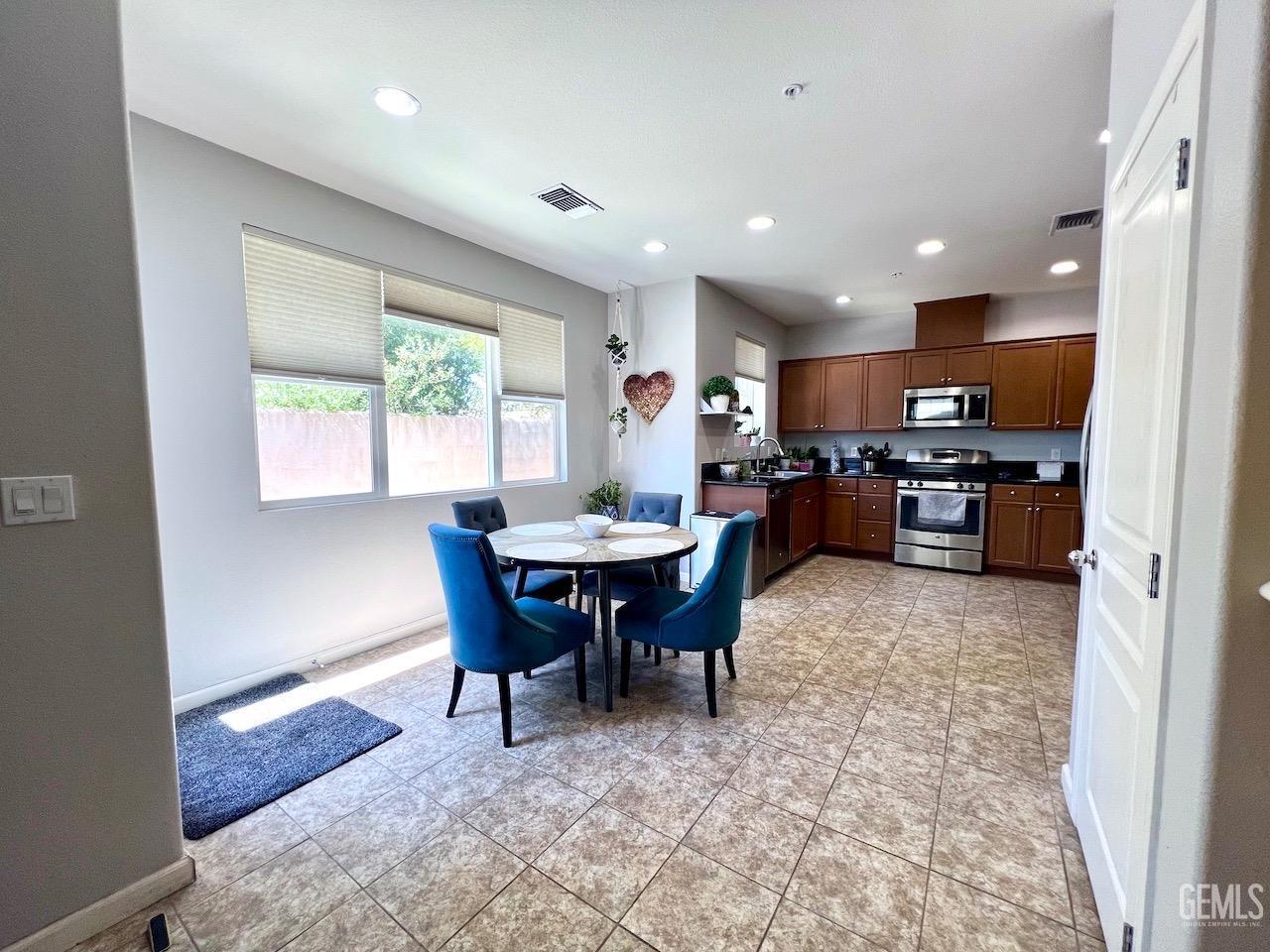 Undisclosed Address Atascadero, CA 93422 - Photo 7 of 30 a kitchen with a dining table chairs and refrigerator