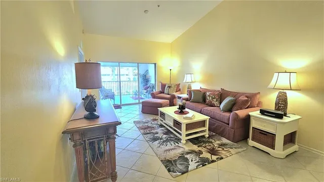 a living room with furniture and a lamp