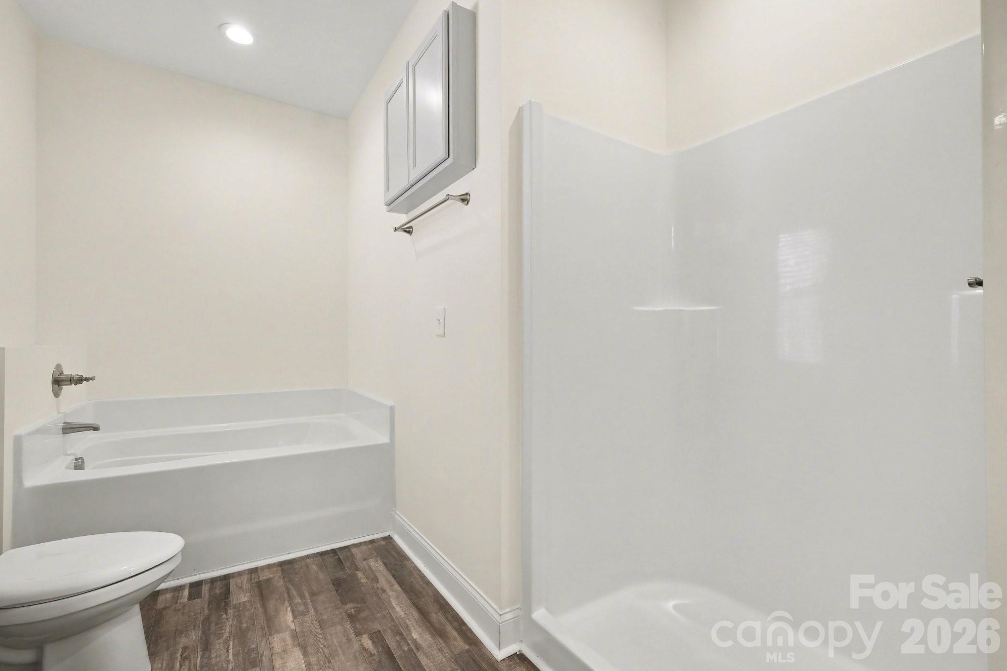 175 Cox Lake Road Stanley, NC 28164 - Photo 14 of 45 a bathroom with a toilet and a bathtub