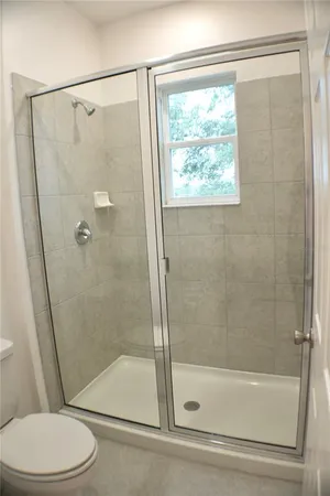 a bathroom with a shower and a toilet