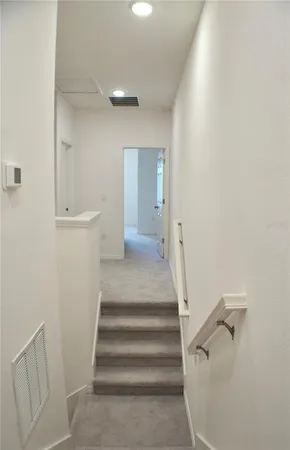a view of a hallway with wooden floor and entryway