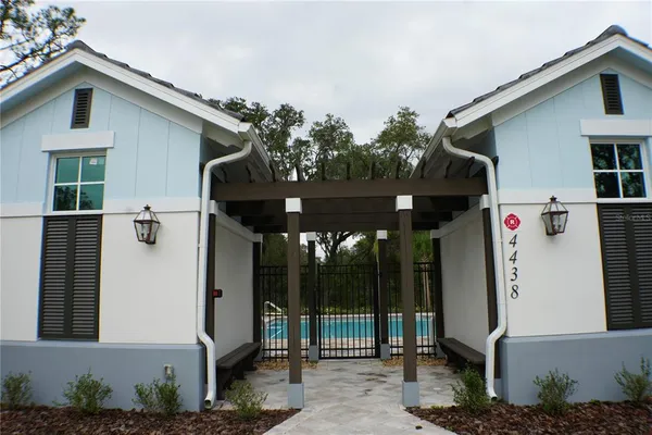 a front view of a house with plants