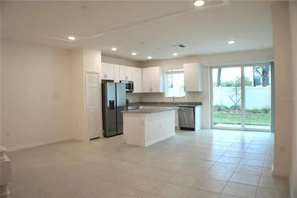 a kitchen with a refrigerator and window