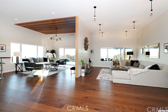 770 Panorama Place Pasadena, CA 91105 - Photo 4 of 35 a living room with couches and kitchen view with wooden floor
