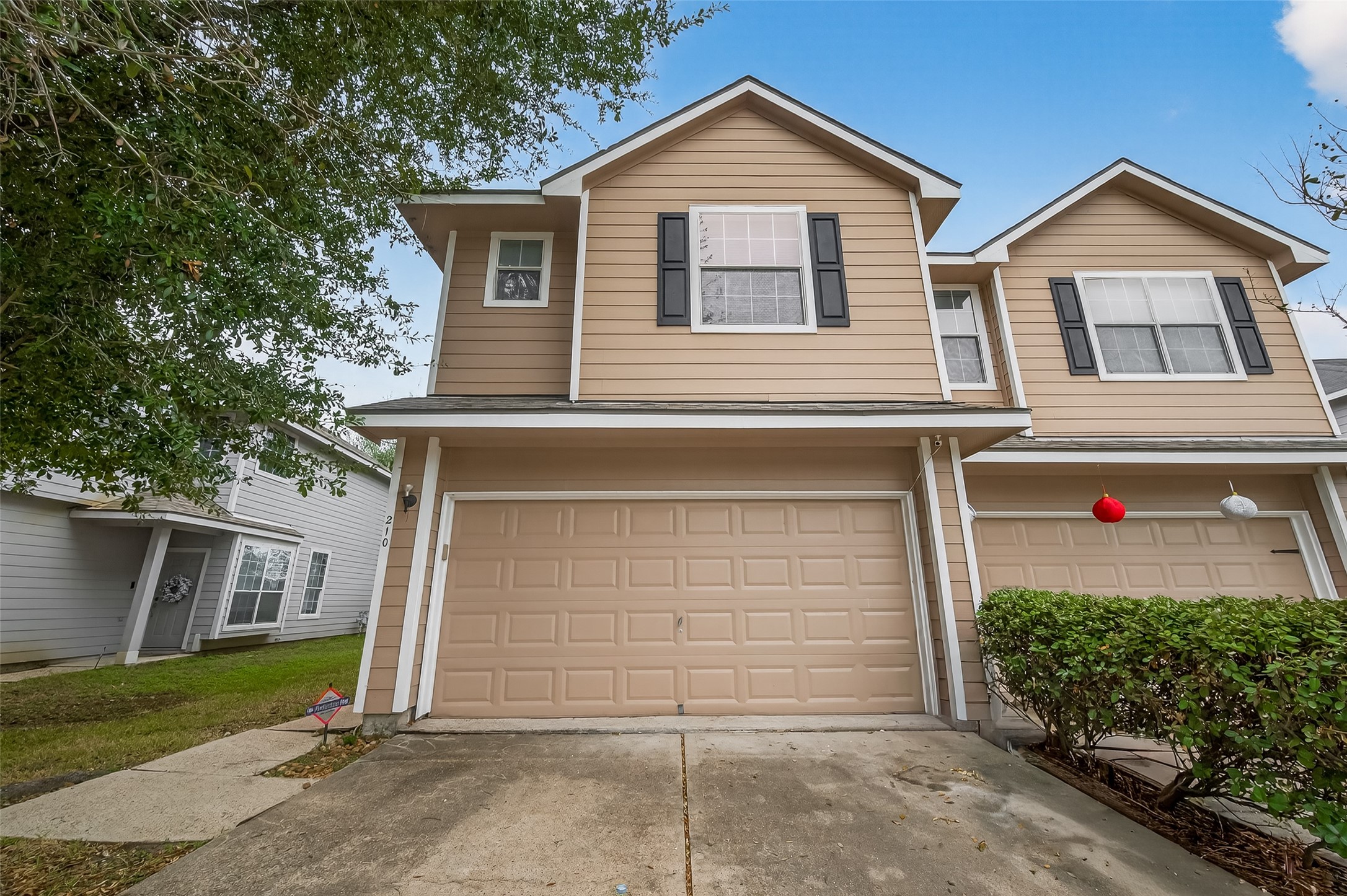 210 Drake Run Lane Dickinson, TX 77539 - Photo 1 of 20 a front view of a house with a yard and garage