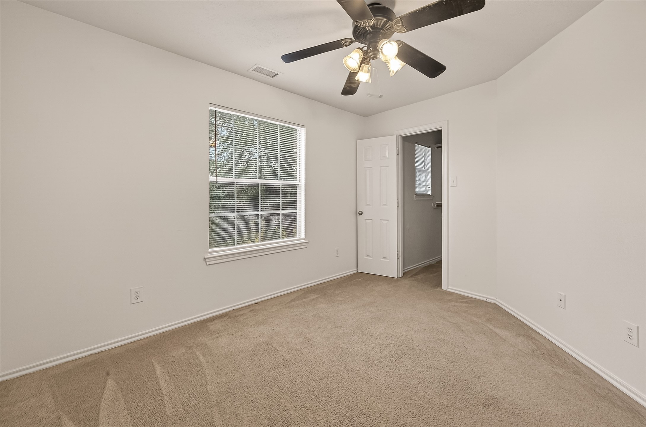 210 Drake Run Lane Dickinson, TX 77539 - Photo 17 of 20 an empty room with windows and fan