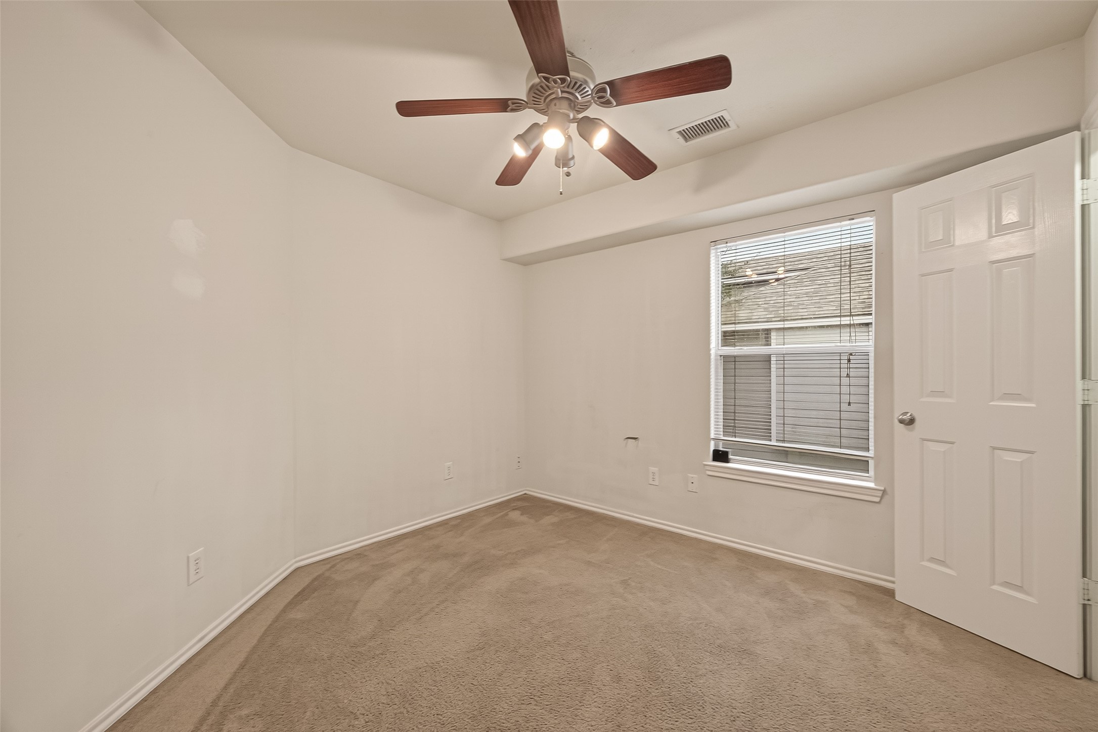 210 Drake Run Lane Dickinson, TX 77539 - Photo 18 of 20 an empty room with windows and fan