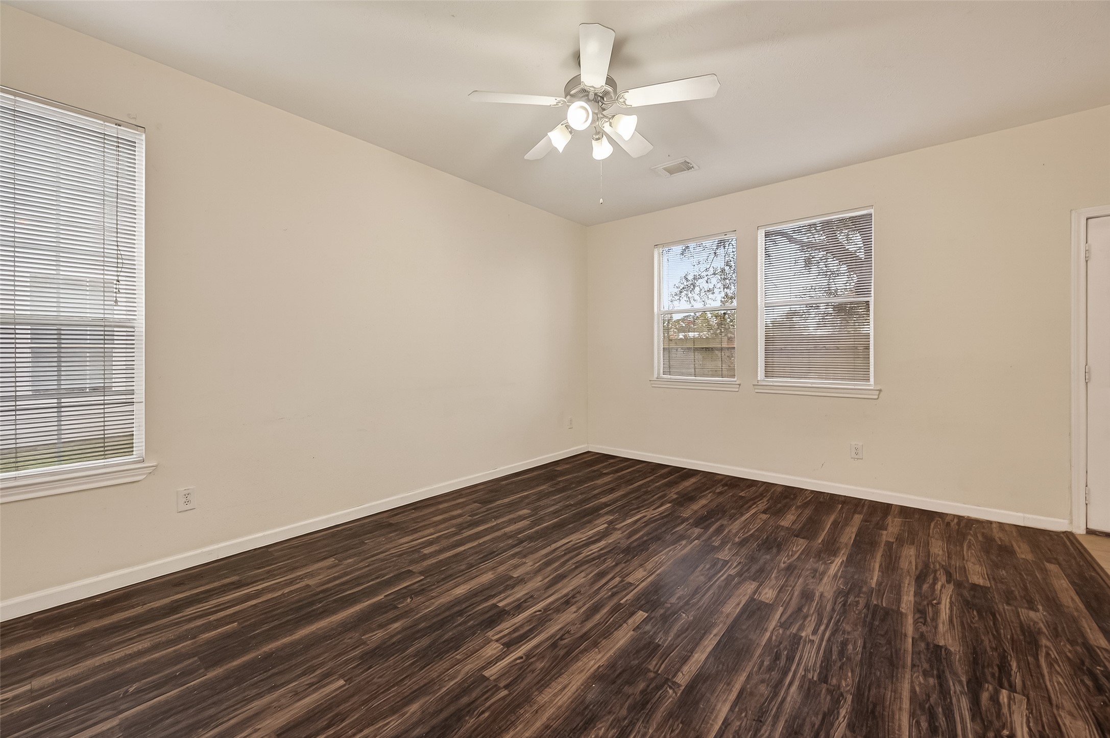 210 Drake Run Lane Dickinson, TX 77539 - Photo 5 of 20 a view of an empty room with wooden floor and a window