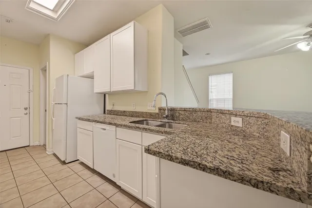 a kitchen with stainless steel appliances granite countertop a sink and a stove