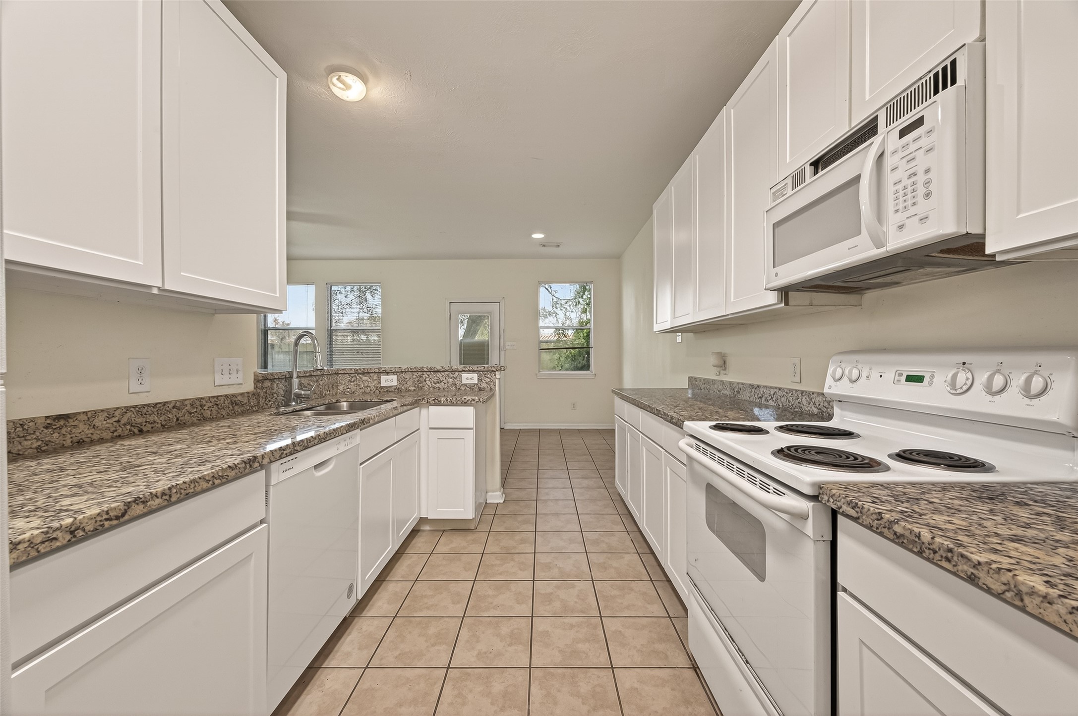 210 Drake Run Lane Dickinson, TX 77539 - Photo 7 of 20 a large kitchen with stainless steel appliances granite countertop a stove and a sink