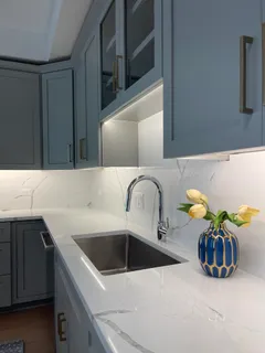 a stove top oven sitting inside of a kitchen