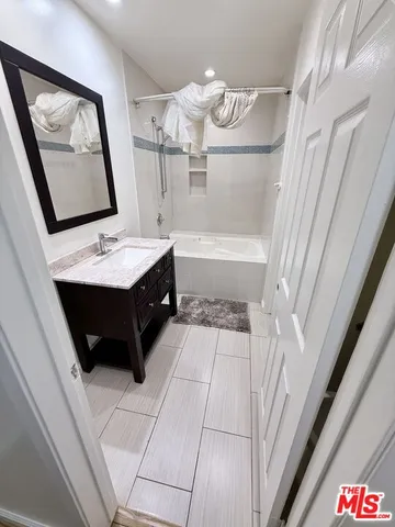 a bathroom with a sink a vanity and a mirror