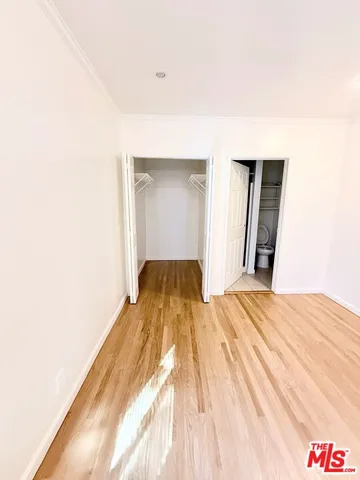 a bedroom with a bed and a mirror