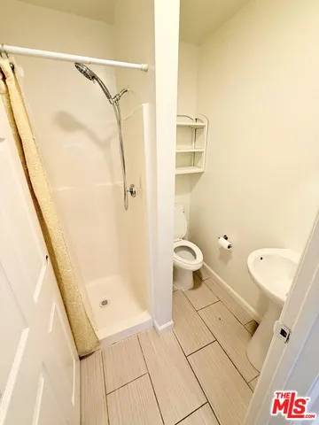 a bathroom with a granite countertop shower and a sink
