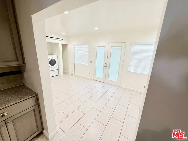 a view of kitchen with furniture and refrigerator