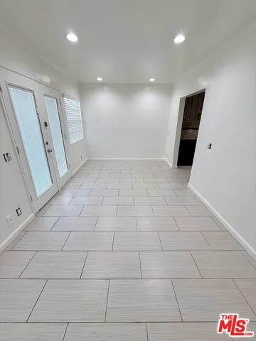 a view of an empty room and a window