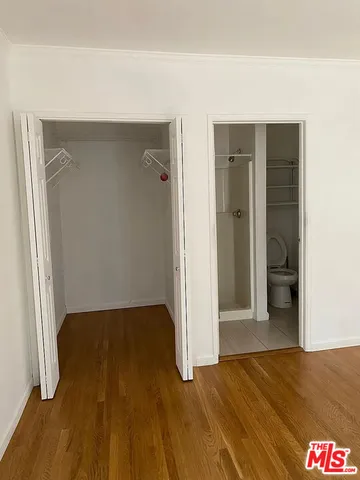 a view of hallway with wooden floor