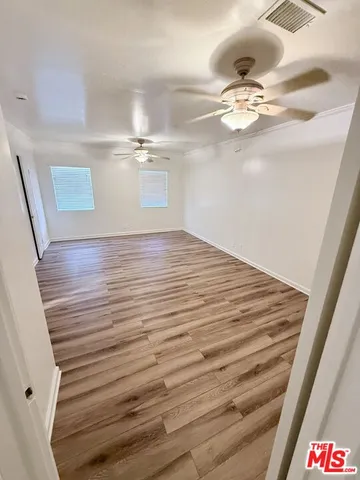 a view of a room with wooden floor