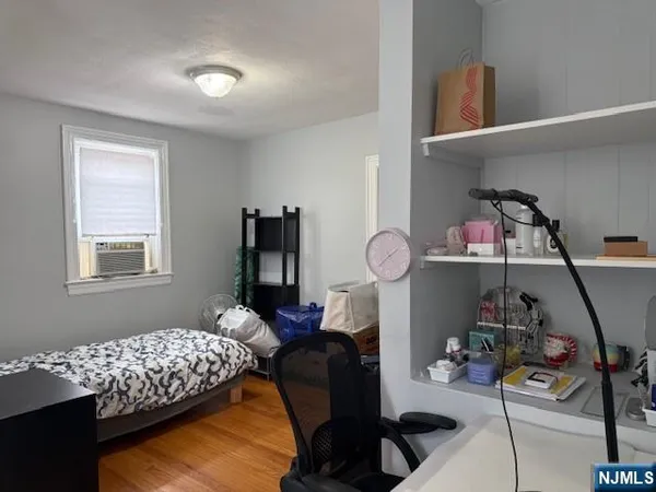 a bedroom with furniture and a window