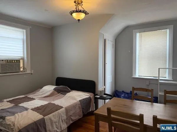 a bedroom with bed and a window