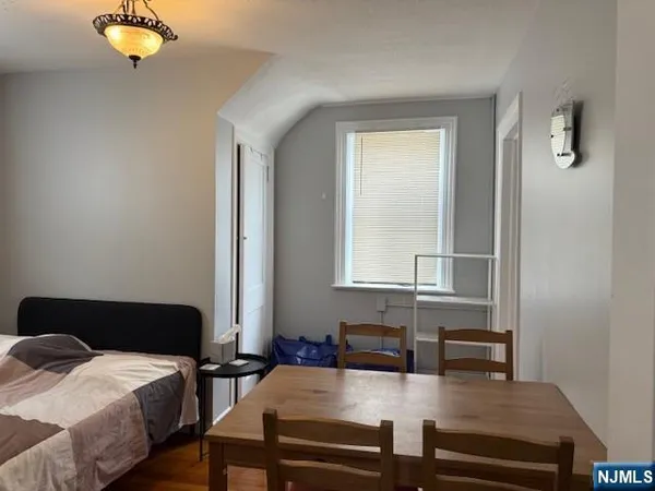 a bedroom with furniture and a window