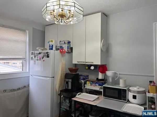 a room with furniture a chandelier a clock and a chandelier