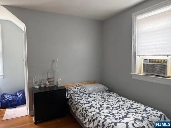 a bedroom with bed and window