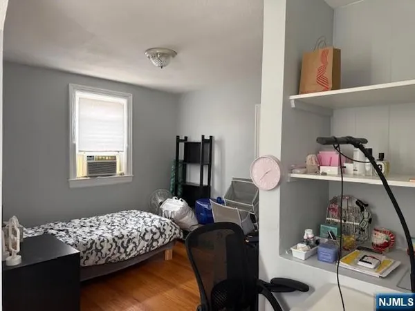 a bedroom with bed and a window