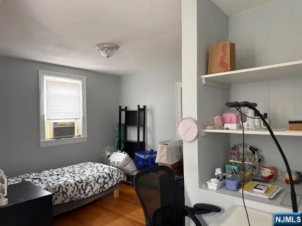 a bedroom with bed and a chandelier
