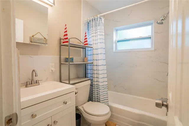 a bedroom with furniture and a flat screen tv