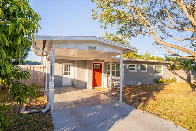 a view of a house with wooden fence next to a road