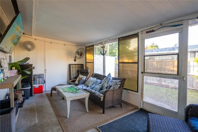 a view of a house with backyard and a tree