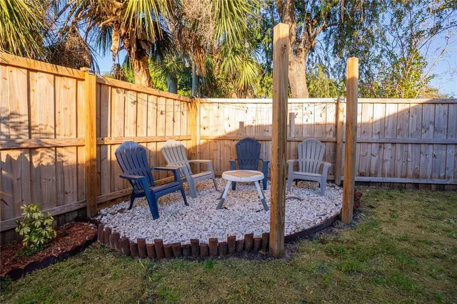 a view of a house with backyard and sitting area