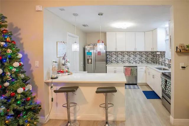 a kitchen with stainless steel appliances kitchen island granite countertop a sink and cabinets