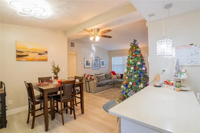 a view of a dining room with furniture and chandelier