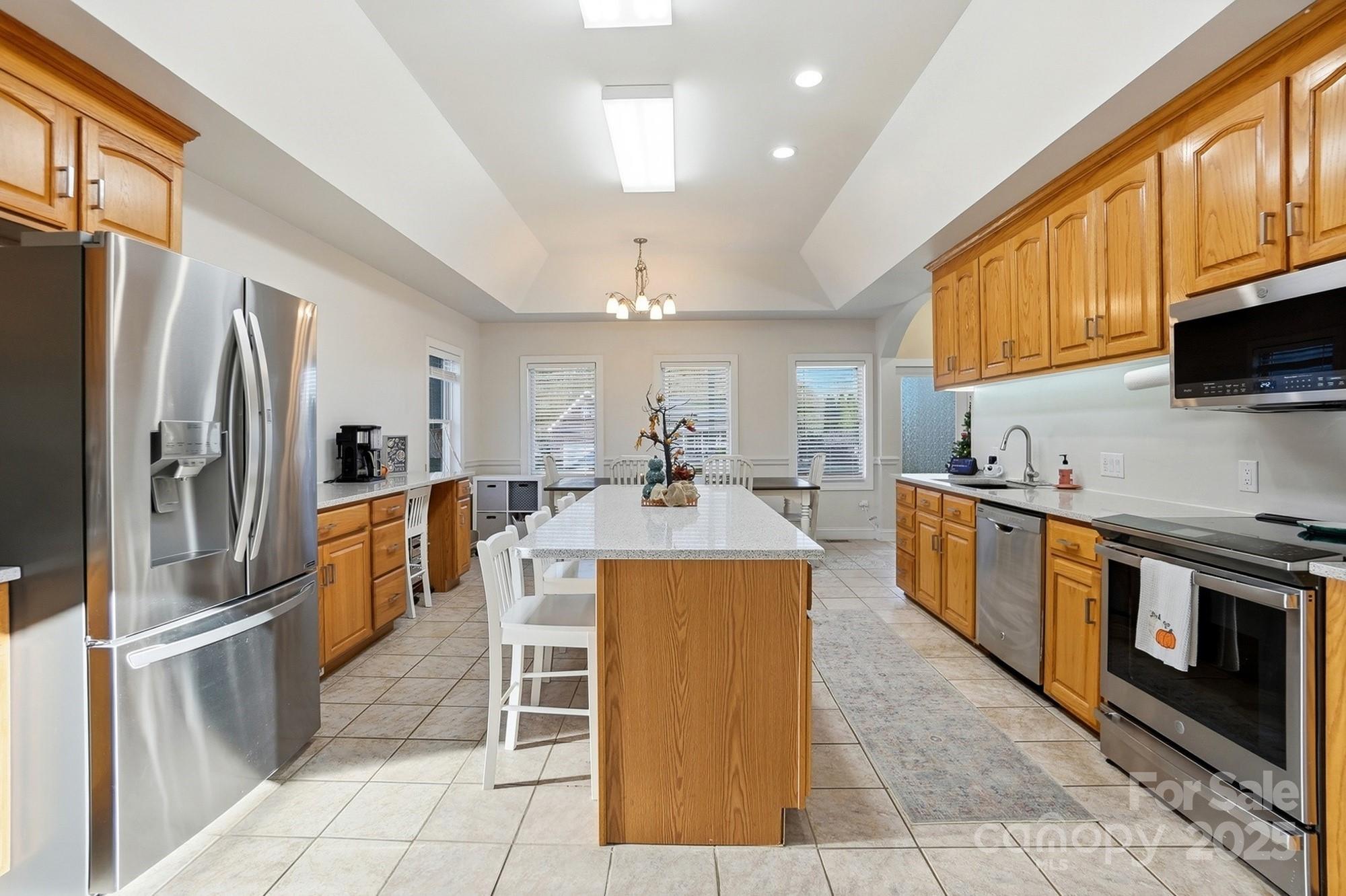845 St Paul Church Road Salisbury, NC 28146 - Photo 12 of 44 a large kitchen with stainless steel appliances granite countertop a stove refrigerator and a microwave