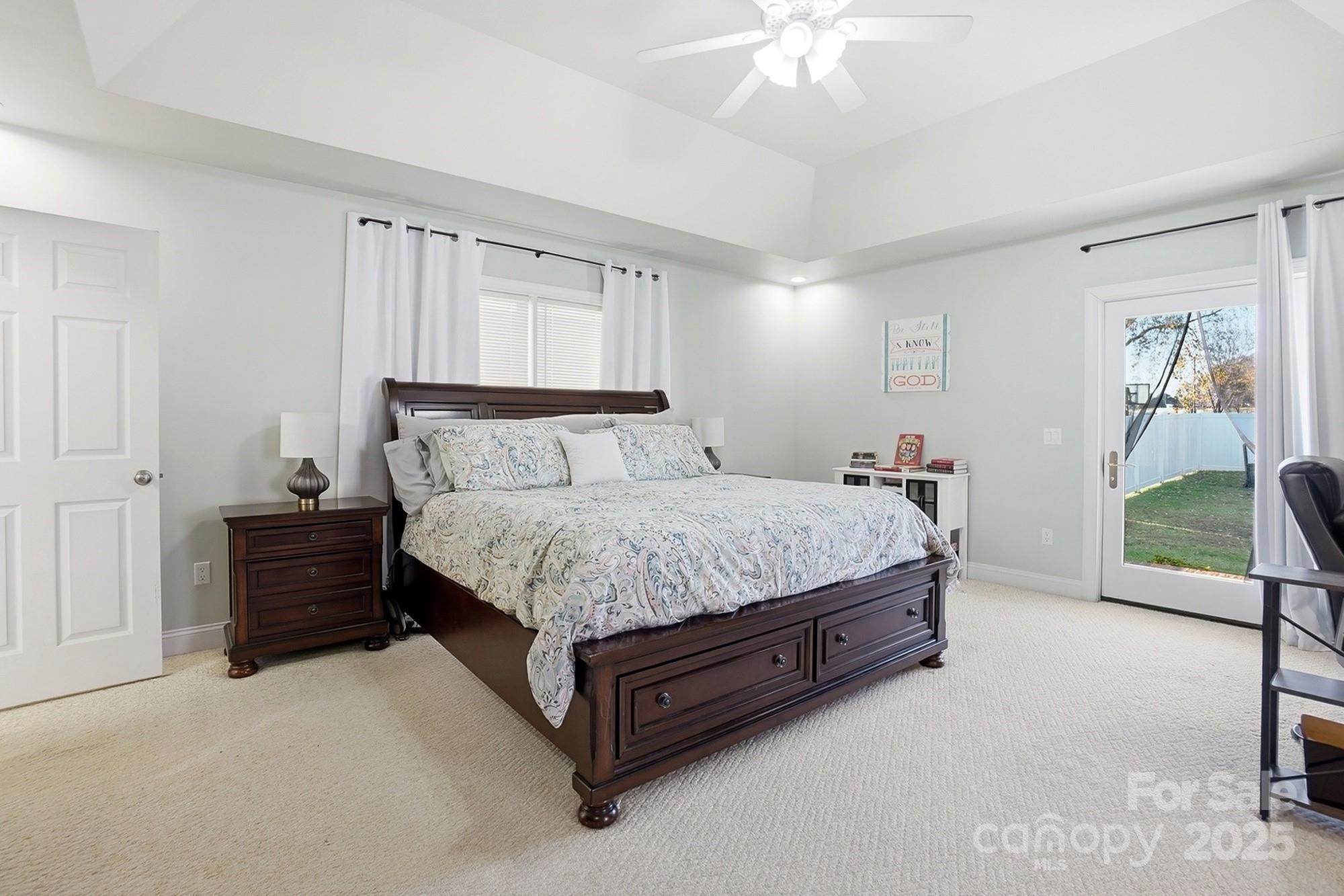 845 St Paul Church Road Salisbury, NC 28146 - Photo 29 of 44 a spacious bedroom with a bed and a chandelier