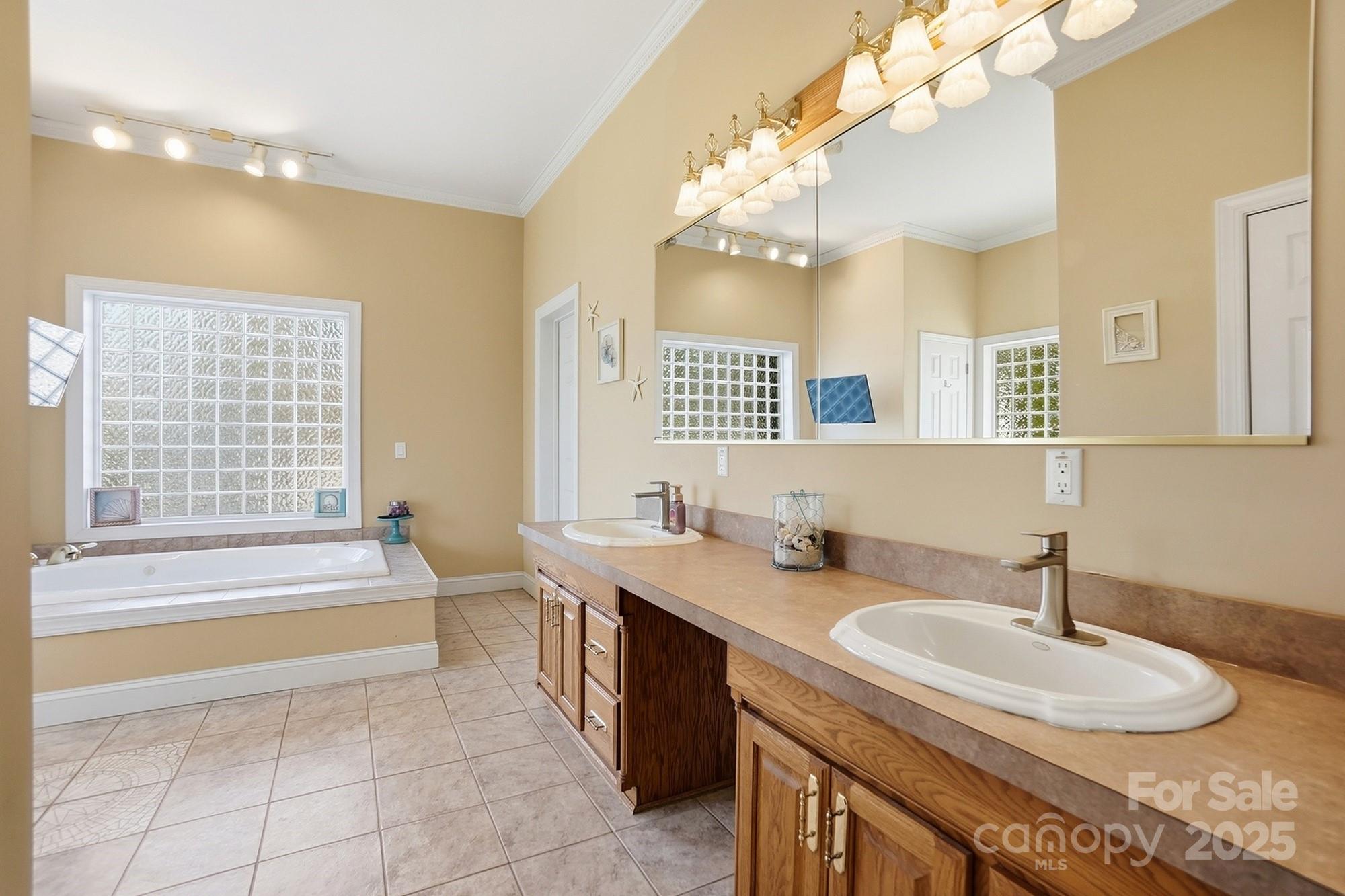 845 St Paul Church Road Salisbury, NC 28146 - Photo 30 of 44 a spacious bathroom with a granite countertop sink a large mirror and a bathtub