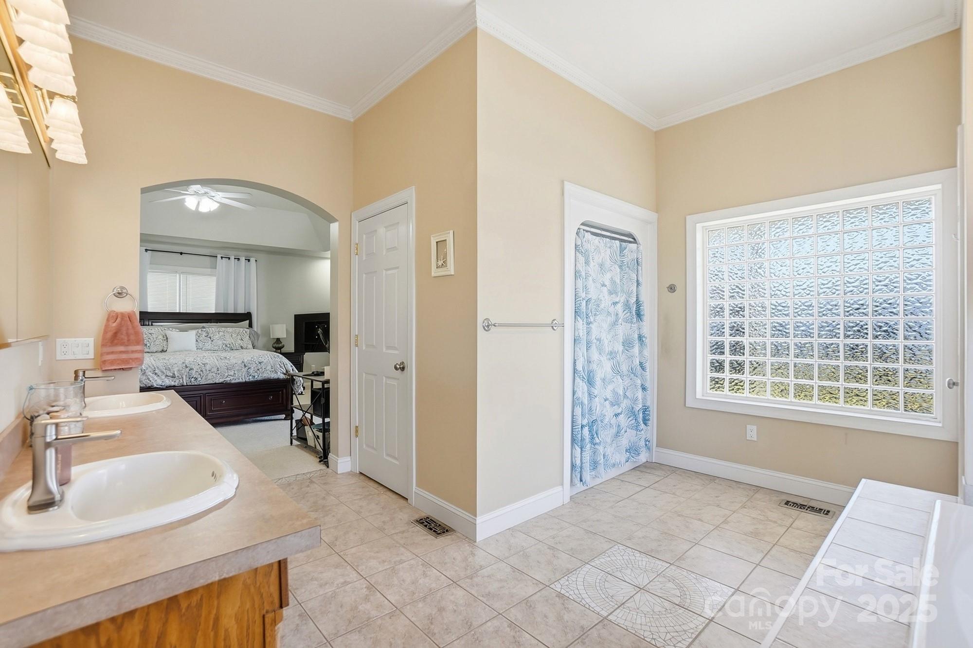 845 St Paul Church Road Salisbury, NC 28146 - Photo 32 of 44 a spacious bathroom with a double vanity sink a mirror and a shower