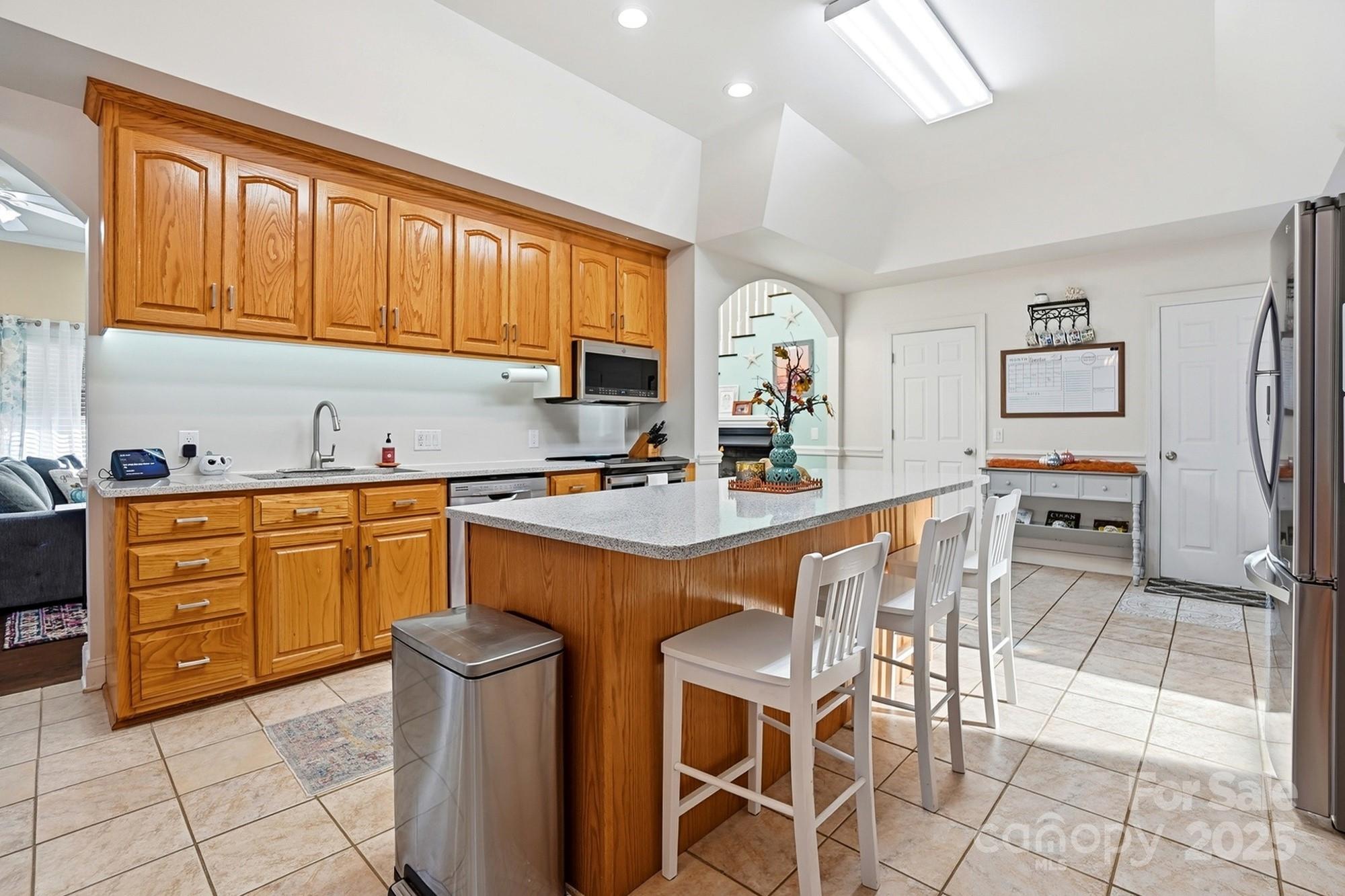 845 St Paul Church Road Salisbury, NC 28146 - Photo 9 of 44 a kitchen with stainless steel appliances granite countertop a stove a sink dishwasher and a refrigerator with wooden cabinets