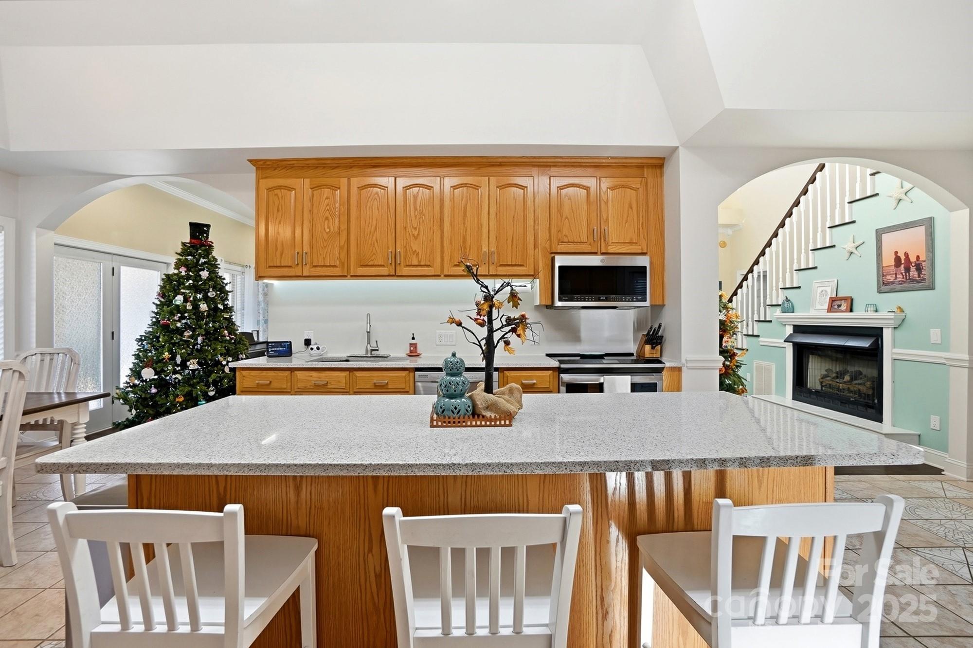 845 St Paul Church Road Salisbury, NC 28146 - Photo 10 of 44 a kitchen with a table chairs and a fireplace