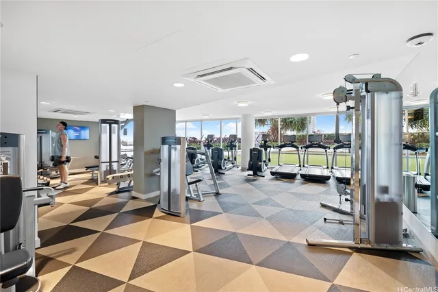 a gym with lots of chairs and mirrors