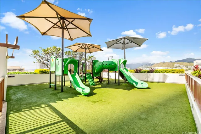 a view of a swimming pool with a patio and a yard