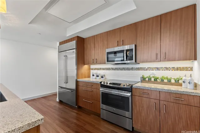 a kitchen with stainless steel appliances a stove microwave and sink