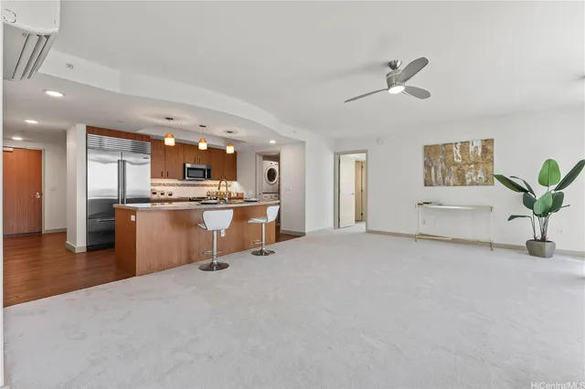 a view of kitchen with furniture and a refrigerator