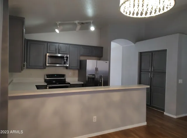 a kitchen with stainless steel appliances a refrigerator a stove a sink and a microwave