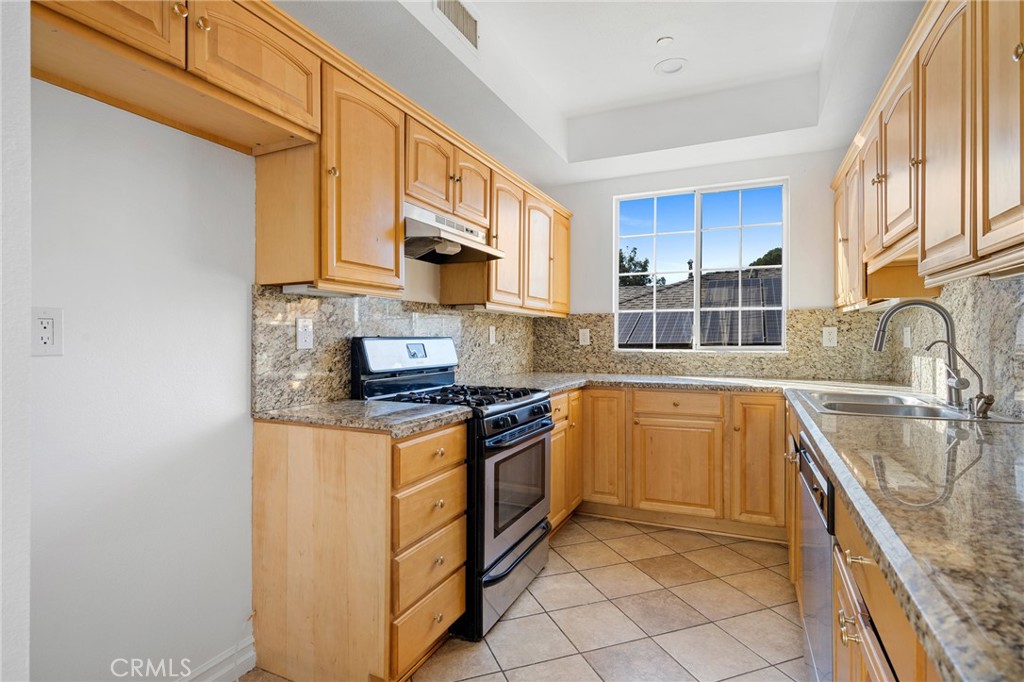 6831 Valmont Street, Unit 1 Tujunga, CA 91042 - Photo 11 of 30 a kitchen with stainless steel appliances granite countertop a sink stove and cabinets